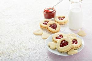 Heart shaped vanilla cookies with jam filling photo