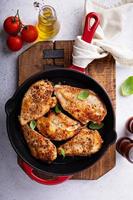 Cooked chicken breast in a skillet photo