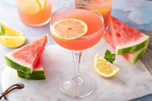 Watermelon and citrus cocktail with lemon garnish photo