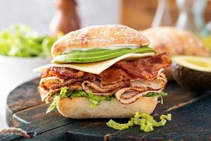 Fresh and healthy avocado turkey sandwich with swiss cheese photo