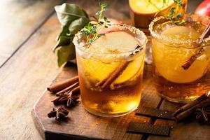 Apple cider margarita with brown sugar rim and cinnamon stick photo