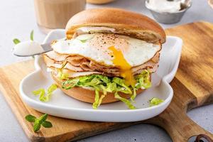 Turkey bagel breakfast sandwich with lettuce and fried egg