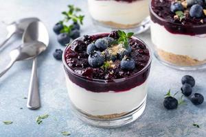 Blueberry cheesecake in a jar with graham cracker base photo