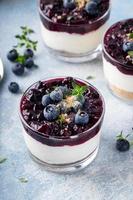 Blueberry cheesecake in a jar with graham cracker base photo