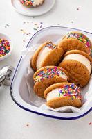 Ice cream and cookies sandwiches stacked on the table photo