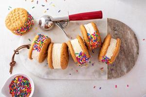 Ice cream and cookies sandwiches stacked on the table photo