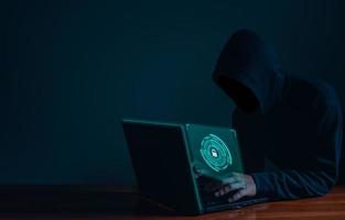 Hackers work on laptops in the dark. The concept of information security in the Internet network and information espionage. photo