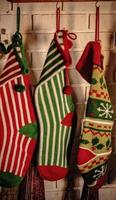 Multicolored Stockings Hanging from a Mantel by the Fire photo