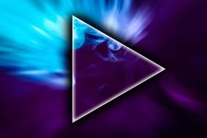 Fog colored with bright pink and blue gel in the shape of a triangle on dark background photo