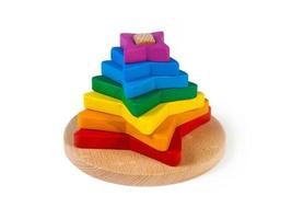 sorter pyramid of colorful parts in the shape of flowerss on a white isolated background. photo