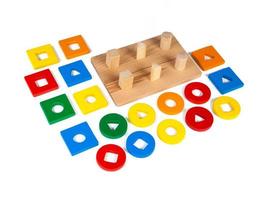 sorter with small wooden details in the form of geometric shapes photo