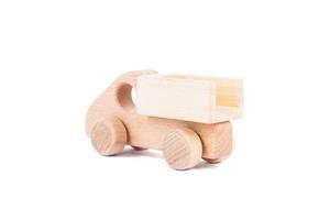 Photo of a wooden car dump truck made of beech on a white isolated background