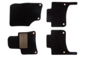 Black floor mats of carpet, velor for the front and rear seats of the car on a white isolated background, top view. photo