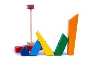 Photo colorful wooden constructor of small arcs, triangles and other forms  in the shape of a ship of beech on a white isolated background