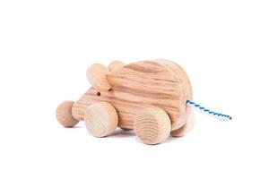 Photo of a wooden mouse on wheels of beech. Toy made of wood mouse car on a white isolated background