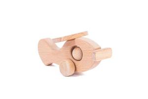 Toy made of wood retro aircraft on a white isolated background photo