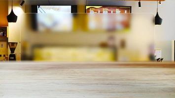 Wooden table with a blur cafe background with an aesthetic interior atmosphere photo