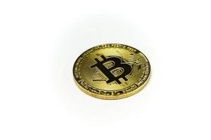 Close up of Golden Bitcoin on white background with selective focus. Symbol of digital money coin. Gold metal coins isolated. Virtual cryptocurrency concept. photo