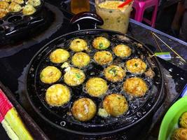 Fry mini eggs in small round pans photo