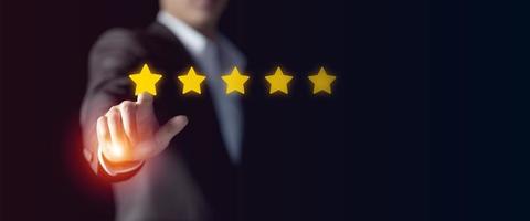 Businessman give rating to service experience, User Experience concept, Customer review satisfaction feedback survey, Customer giving a Five Star to business ranking photo