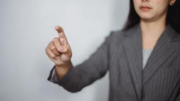 Young woman pointing at something on a white background photo