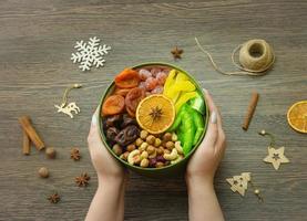 assorted dried fruit nuts and candied fruit in a box, top view photo