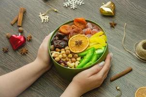 assorted dried fruit nuts and candied fruit in a box, top view photo