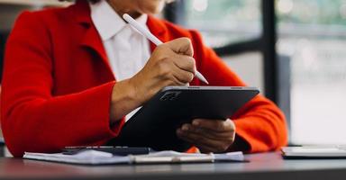 Woman hand using smart phone and laptop in outdoor nature park and sunset sky with bokeh light abstract background. Technology business and freelance working concept. Vintage tone filter color style. photo