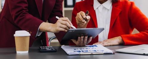 Businessman hands working with finances about cost and calculator and laptop with tablet, smartphone at office in morning light photo