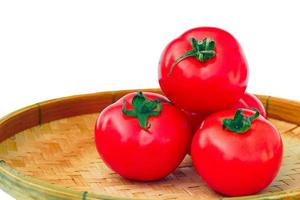 Fresh red ripe tomatoes in bamboo baskets on white background. soft and selective focus. photo