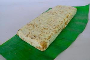 Raw tempeh or tempe. tempeh slices in white background. raw soybean seeds. Tempe is a traditional Indonesian food made from fermented soybeans. photo
