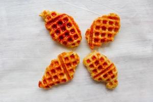 Croissant Waffle or Croffle with chocolate sauce served in box and white background photo