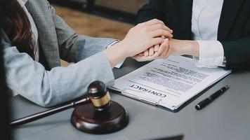 Justice and law concept.Male judge in a courtroom with the gavel, working with, computer and docking keyboard, eyeglasses, on table in morning light video