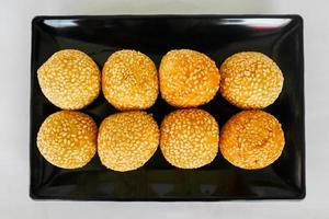 onde-onde or sesame ball or Jian Dui is fried Chinese pastry made from glutinous rice flour and coated with sesame seeds filled with bean paste. isolated on white background photo