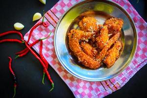 Delicious homemade crispy fried chicken with spicy taste and lemon on plate photo