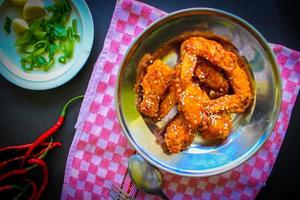 Delicious homemade crispy fried chicken with spicy taste and lemon on plate photo