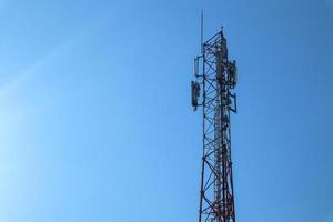 communication tower. Telco Trellis for 3G 4G 5G Apocalypse Internet Communication, mobile, FM Radio and Television Broadcasting On Air with Blue Sky in Background photo