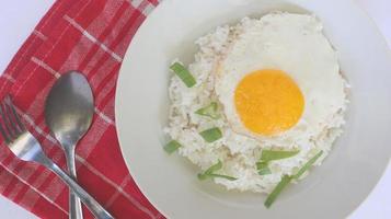 fried egg rice. breakfast fried egg sunny side rice on a plate, isolated on white background photo