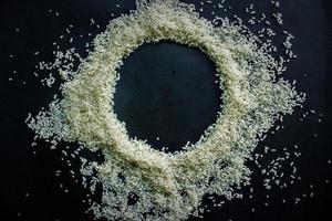 Raw rice from Indonesia with look circle shape in the center isolated on black background photo