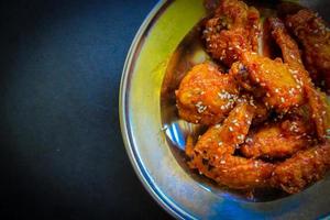 Delicious homemade crispy fried chicken with spicy taste and lemon on plate photo