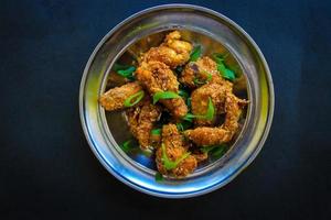 Delicious homemade crispy fried chicken with spicy taste and lemon on plate photo