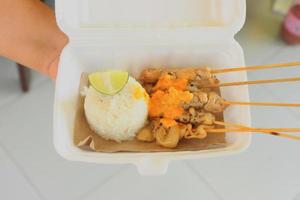 sate taichan or taichan satay , made from chicken meat, served with Sauce, Ketchup and lime. this food like yakitori photo