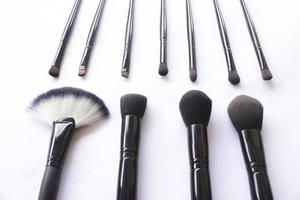 makeup brushes set isolated on white background. Top view, flat lay photo