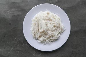 bihun or vermicelli or rice noodles or angel hair served on plate isolated on black background photo