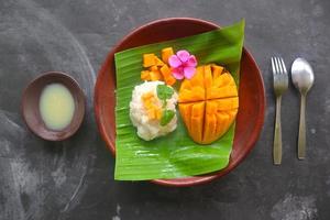 mango sticky rice is Thai dessert made of sticky rice, mango and coconut milk. photo