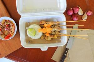 sate taichan or taichan satay , made from chicken meat, served with Sauce, Ketchup and lime. this food like yakitori photo