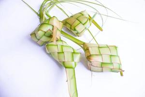 ketupat in earthenware plate isolated on white background. photo