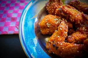 Delicious homemade crispy fried chicken with spicy taste and lemon on plate photo