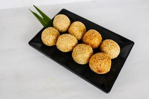 onde-onde or sesame ball or Jian Dui is fried Chinese pastry made from glutinous rice flour and coated with sesame seeds filled with bean paste. isolated on white background photo