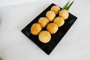 onde-onde or sesame ball or Jian Dui is fried Chinese pastry made from glutinous rice flour and coated with sesame seeds filled with bean paste. isolated on white background photo